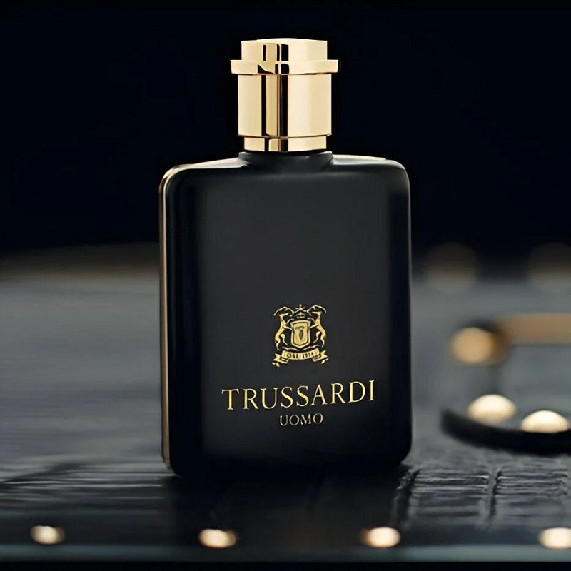Trussardi perfume bottle on a dark textured surface with a blurred background