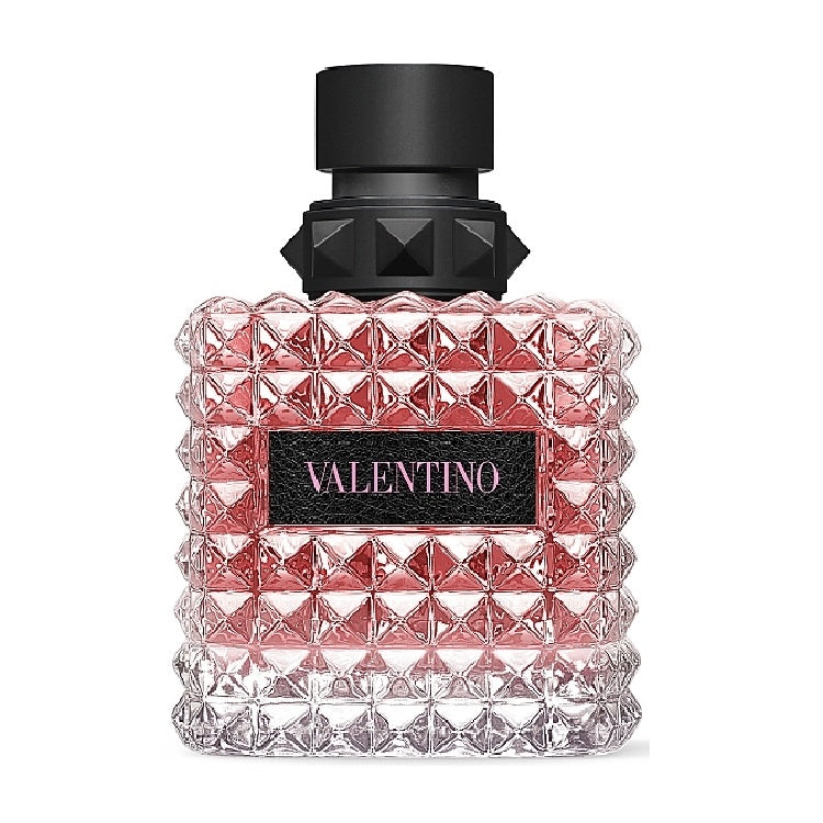 A glass bottle of Valentino Donna Born In Roma perfume with a black cap and a pink-hued body featuring a geometric pattern.