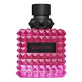 Pink diamond-patterned perfume bottle with black cap on a white background