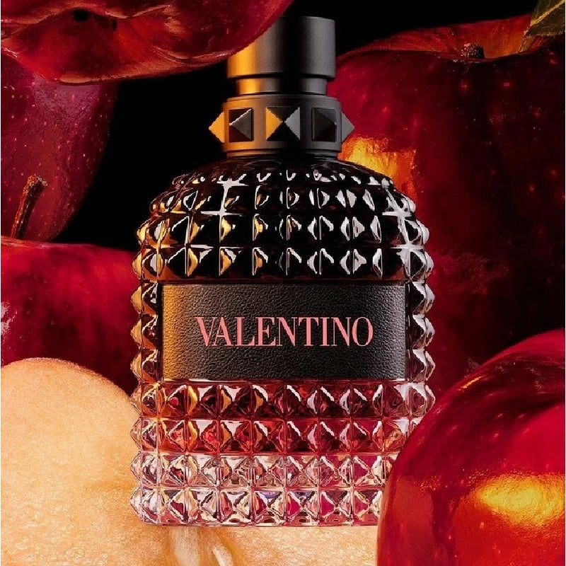 Valentino perfume bottle with red fruits in the background