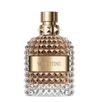 A glass bottle of Valentino Uomo Eau de Toilette with a gold cap and label, the fragrance scent is leather woody.