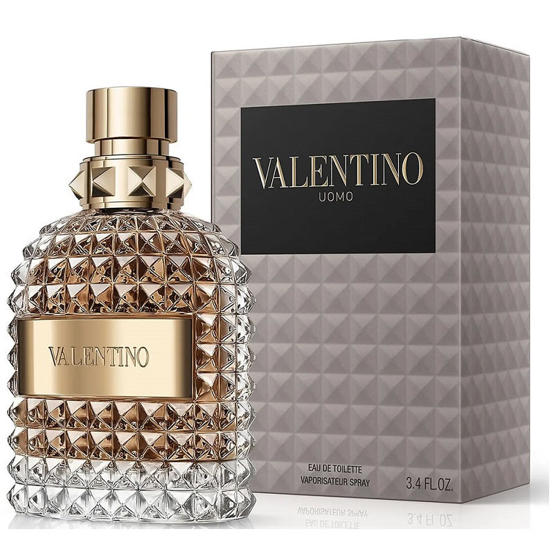 A glass bottle of Valentino Uomo Eau de Toilette with a gold cap and label, the fragrance scent is leather woody.