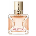 A clear glass bottle of Valentino Voce Viva Intensa eau de parfum with a gold cap and pink-toned liquid visible inside.