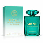 Versace Crystal Emerald Eau de Parfum bottle in a translucent teal glass with a faceted cap, shown next to its matching teal and white packaging box with gold lettering.