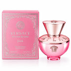 Versace Dylan Blush pink Eau de Parfum natural spray bottle next to its pink packaging box, featuring the iconic Medusa logo and rose gold metallic accents.