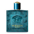 Versace Eros fragrance bottle in a translucent teal blue glass with a gold Medusa emblem and gold lettering, topped with a metallic blue and gold cap, on a white background.