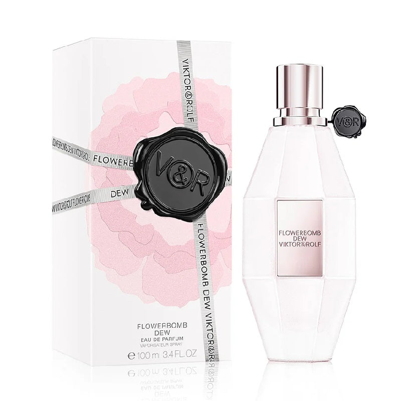 A product image showing the packaging and bottle of Flowerbomb Dew Eau de Parfum by Viktor & Rolf. The packaging is predominantly white with floral motifs and the bottle is white with a silver cap.