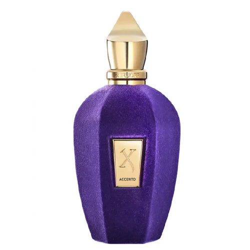 A purple velvet perfume bottle with a gold cap and a gold front label featuring an 'X' logo and the word 'ACCENTO'.