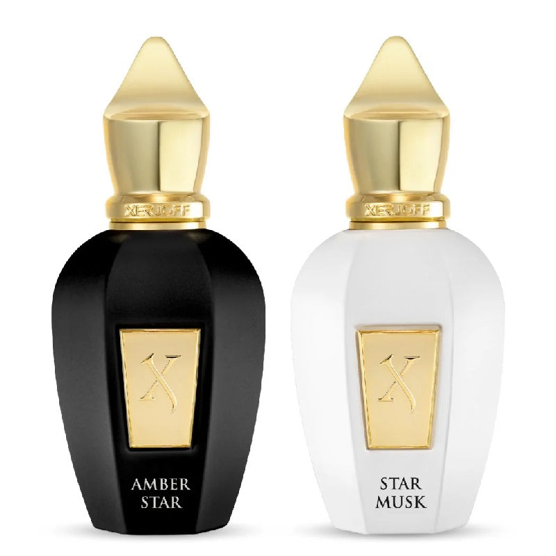 Two perfume bottles, one black and one white, with gold caps and labels on a white background.