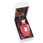 Pink perfume bottle with gold cap in an open box on a white background