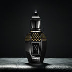 Black and gold perfume bottle with 'X' symbol on a dark background