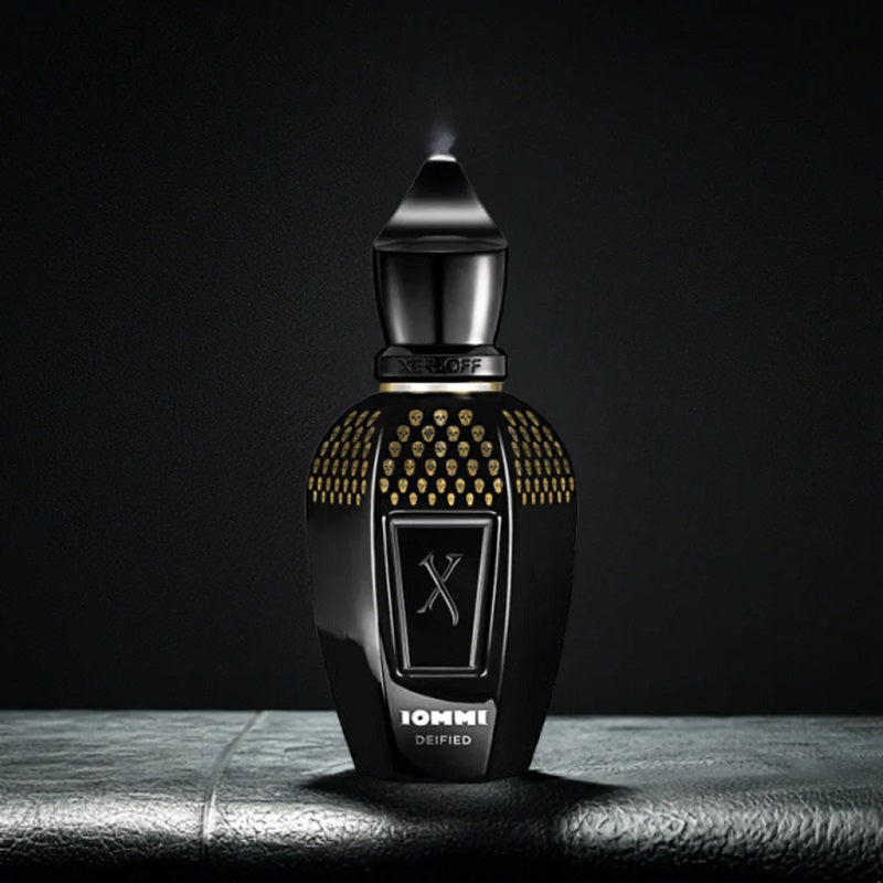Black and gold perfume bottle with 'X' symbol on a dark background