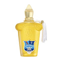A yellow glass bottle of Casamorati Dolce Amalfi Eau de Parfum by Xerde, with a label featuring a blue and white crest and a white tassel on the cap.