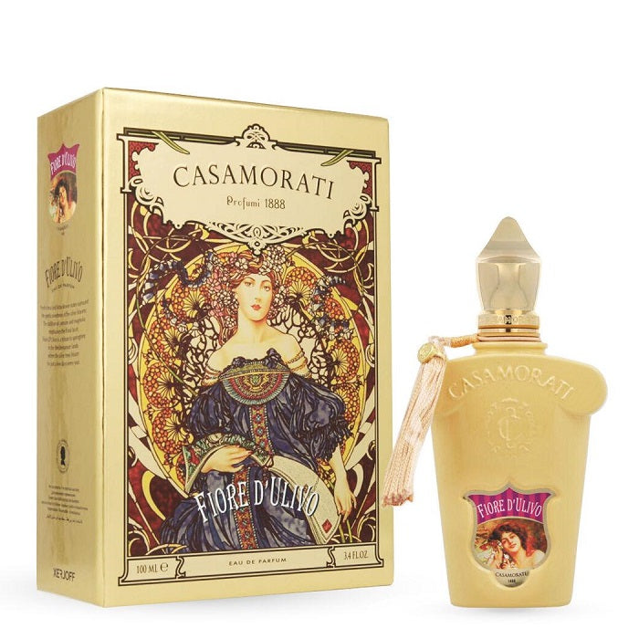 The product image features the Casamorati Fiore D'ulivo Eau de Parfum by Xerjoff in a 100ml bottle with a gold-colored label and packaging. The design includes an illustration of a woman wearing a floral dress.