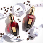 Two red perfume bottles with gold caps on a white background with coffee beans.