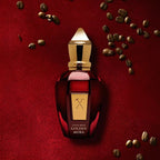 Perfume bottle labeled 'Golden Moka' on a red textured background with coffee beans.