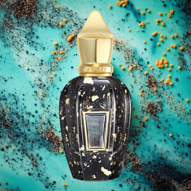 Decorative perfume bottle with gold accents on a textured blue background
