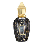 Perfume bottle with gold cap and black and gold speckled body on a white background