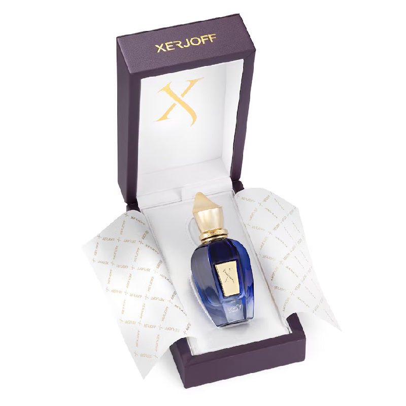 Perfume bottle with gold cap in a Xerjoff box on a white background