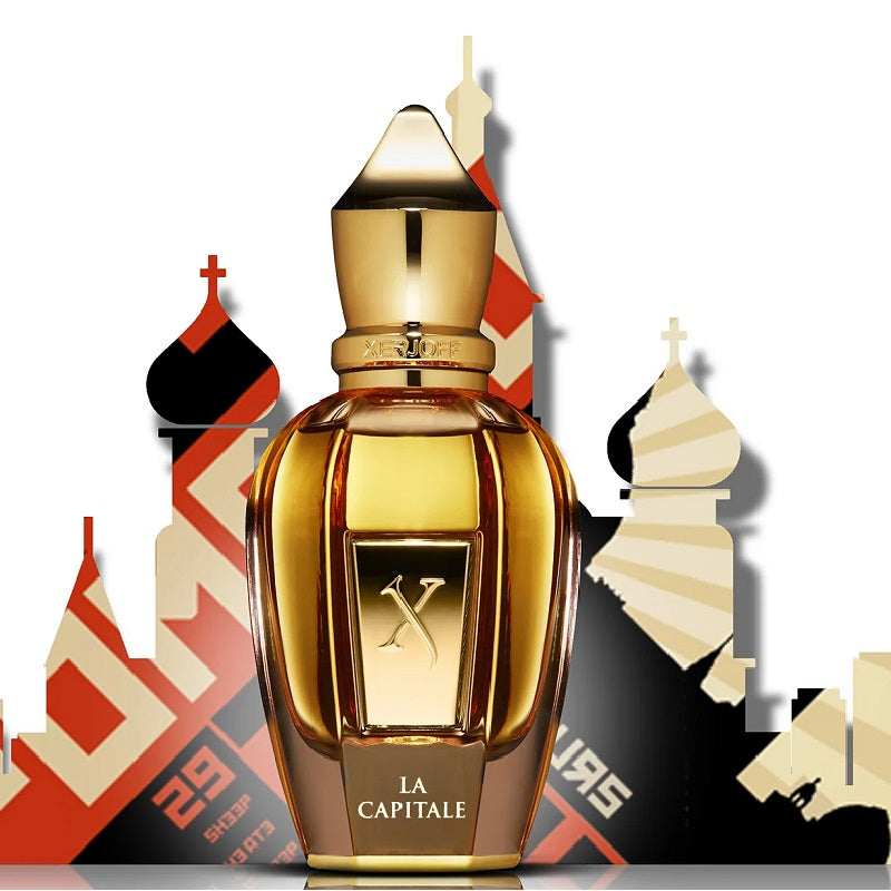 Gold perfume bottle with 'La Capitale' text against a colorful architectural background
