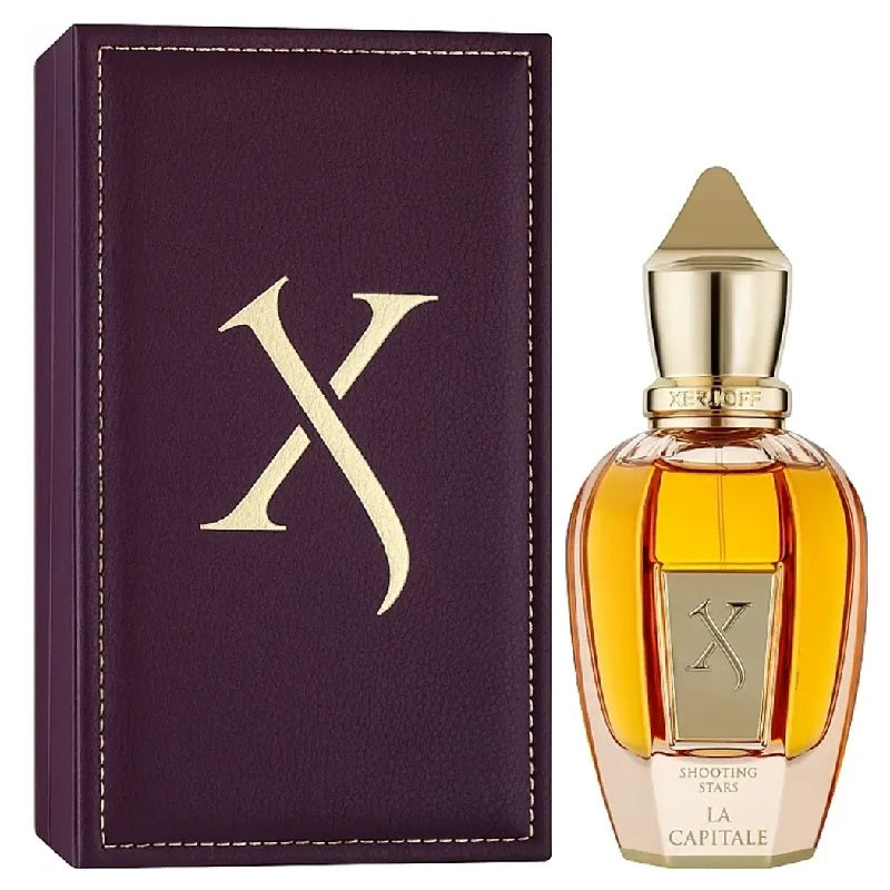 La Capitale Perfume bottle with gold cap and 'X' logo next to a purple box with 'X' logo