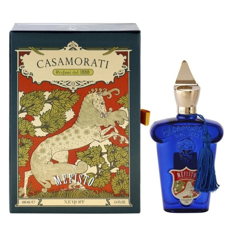 A product image featuring a blue perfume bottle with a white label, next to its packaging box with a unicorn illustration.