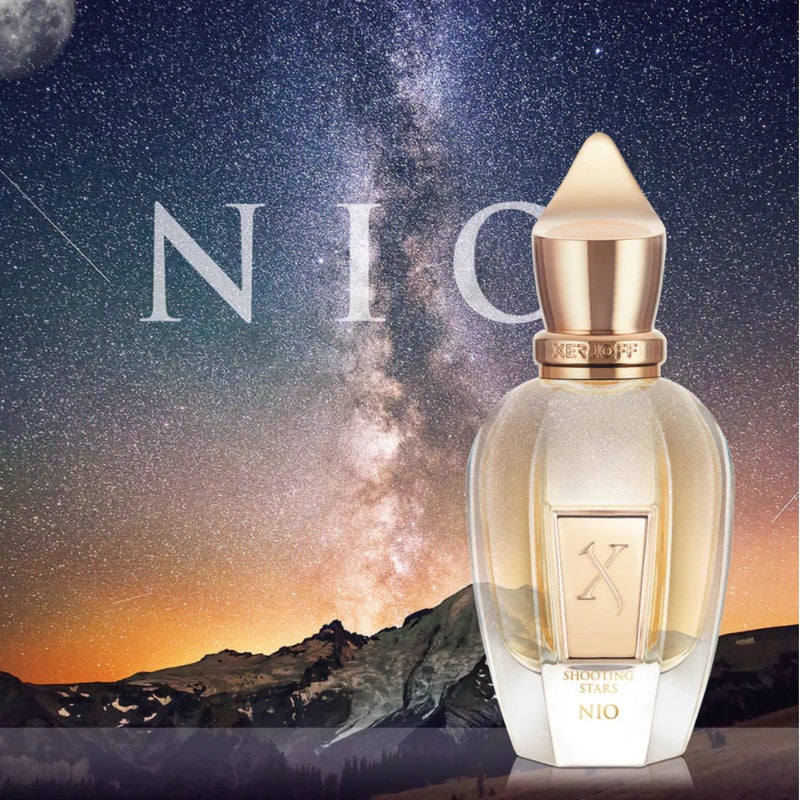 Perfume bottle with 'NIO' branding against a starry night sky and mountain landscape