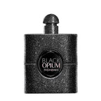A bottle of Yves Saint Laurent Black Opium perfume, featuring a textured black glittery rectangular bottle with a matching black cap and a circular black label on the front.