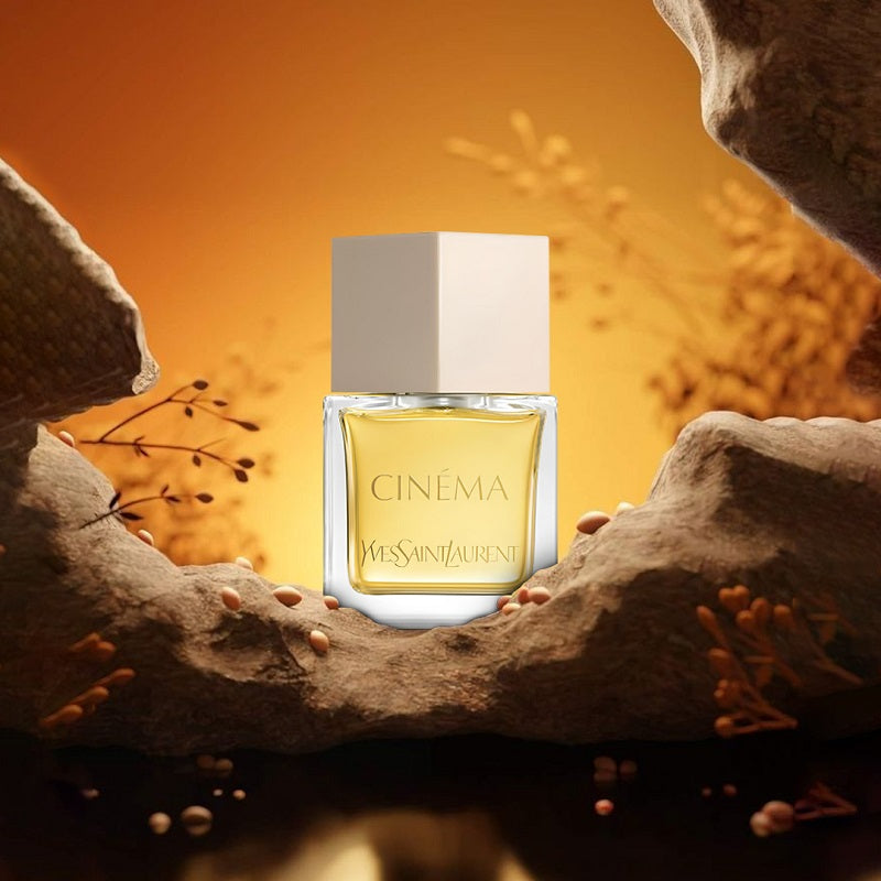 Yves Saint Laurent Cinema perfume bottle on a stone surface with an orange background