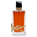 A glass bottle of Libre Le Parfum by Yves Saint Laurent with a gold design element, containing orange-colored liquid.