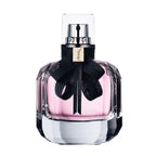 Perfume bottle with black ribbon and Yves Saint Laurent logo on a white background