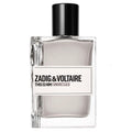 A bottle of Zadig & Voltaire This Is Him! Undressed fragrance, featuring a clear glass bottle with a black cap and a white label with black text, set against a plain white background.