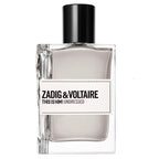 A bottle of Zadig & Voltaire This Is Him! Undressed fragrance, featuring a clear glass bottle with a black cap and a white label with black text, set against a plain white background.