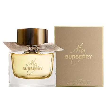 A bottle of My Burberry 90ml Eau De Parfum with its packaging box, featuring a clear glass bottle with a gold cap, a beige ribbon, and the brand name 'Burberry' displayed on the box.