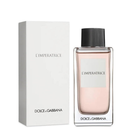 A bottle of Anthology L'Imperatrice Eau de Toilette by Dolce Gabbana with its white box packaging. The bottle is transparent, revealing a pinkish liquid, with a black cap and the brand name printed directly on it.