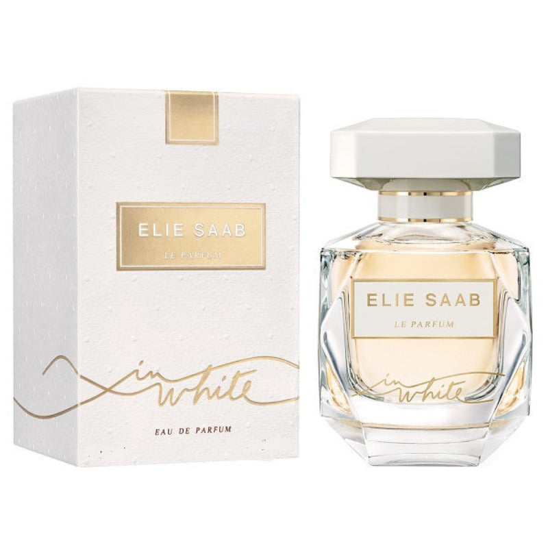 A bottle of 'Le Parfum In White' Eau de Parfum by Elie Saab, with a white cap and clear glass bottle, alongside its white box packaging with gold accents.