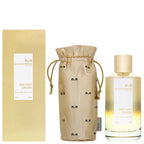 A bottle of Instant Crush Eau de Parfum by Mancera, with a beige packaging bag, placed in front of a yellow backdrop.