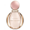 A glass bottle of Bvlgari Rose Goldea eau de parfum with a pink cap and a gold label.