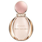 A glass bottle of Bvlgari Rose Goldea eau de parfum with a pink cap and a gold label.