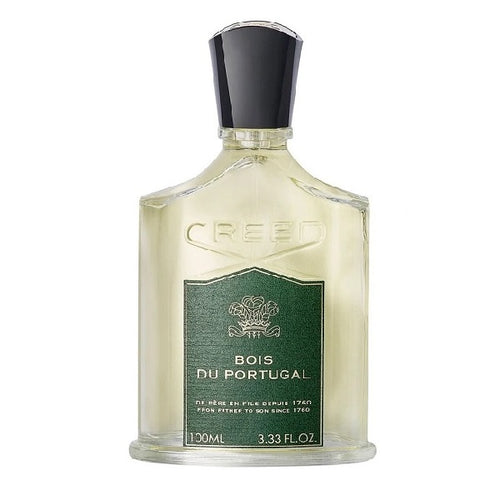 A bottle of Creed Bois du Portugal eau de parfum with a green label, white liquid, and a black cap.