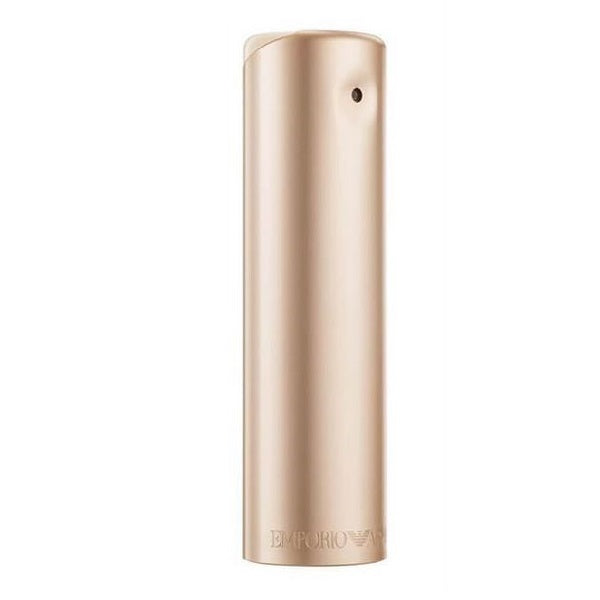 A cylindrical bottle of Emporio Armani She eau de parfum in a gold color with a cap and without visible branding.