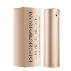 A product image featuring a Armani She (100ml) Eau de Parfum by Emporio Armani, with a gold-colored bottle and packaging.