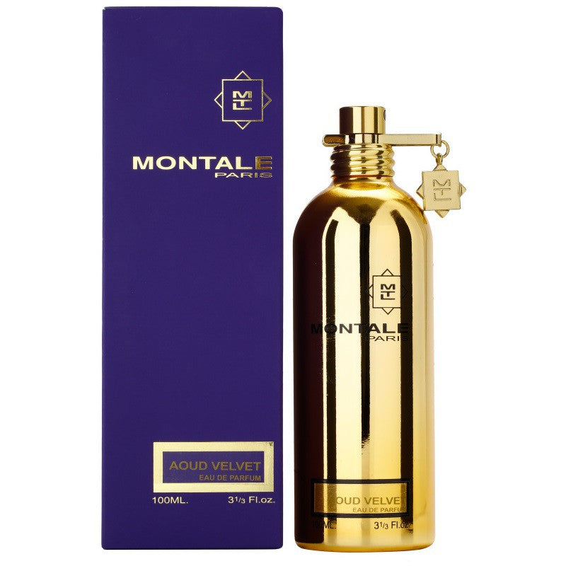 A gold-colored bottle of Montale Aoud Velvet Eau de Parfum, with a purple box packaging behind it.