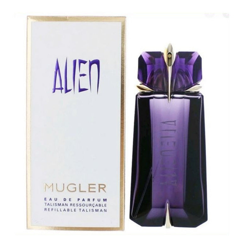 A purple bottle of Alien Talisman Eau de Parfum by Mugler, with the product name and the number 60ml visible on the packaging. The bottle is designed in the shape of a talisman.