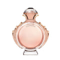 A glass bottle of Olympea Eau de Parfum by Paco Rabanne with a pink and gold label, the bottle is filled with a pink liquid.