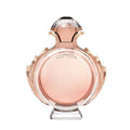 A glass bottle of Olympea Eau de Parfum by Paco Rabanne with a pink and amber liquid visible, along with a crystal-like cap.