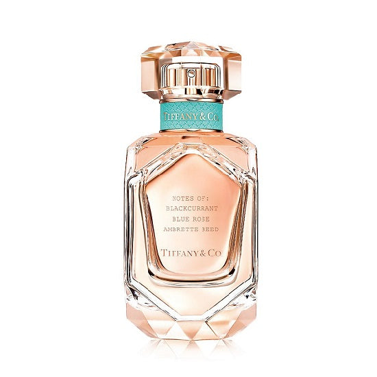 A bottle of Tiffany & Co. Rose Gold Eau de Parfum with a clear, faceted glass design and a rose gold cap.