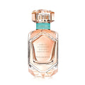 A bottle of Tiffany & Co. Rose Gold Eau de Parfum with a clear, faceted glass design and a rose gold cap.