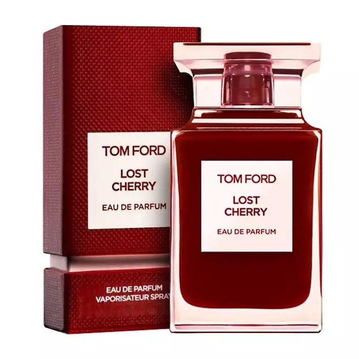 A product image featuring a Tom Ford Lost Cherry Eau de Parfum bottle with a clear, dark red liquid visible inside. The packaging is predominantly red with white text displaying the brand and perfume name.