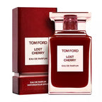 A product image featuring a Tom Ford Lost Cherry Eau de Parfum bottle with a clear, dark red liquid visible inside. The packaging is predominantly red with white text displaying the brand and perfume name.